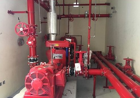 Fire pump with red motor and valve pipework