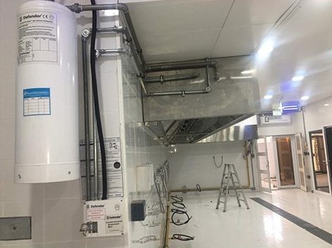 White storage cylinder installed in a service room